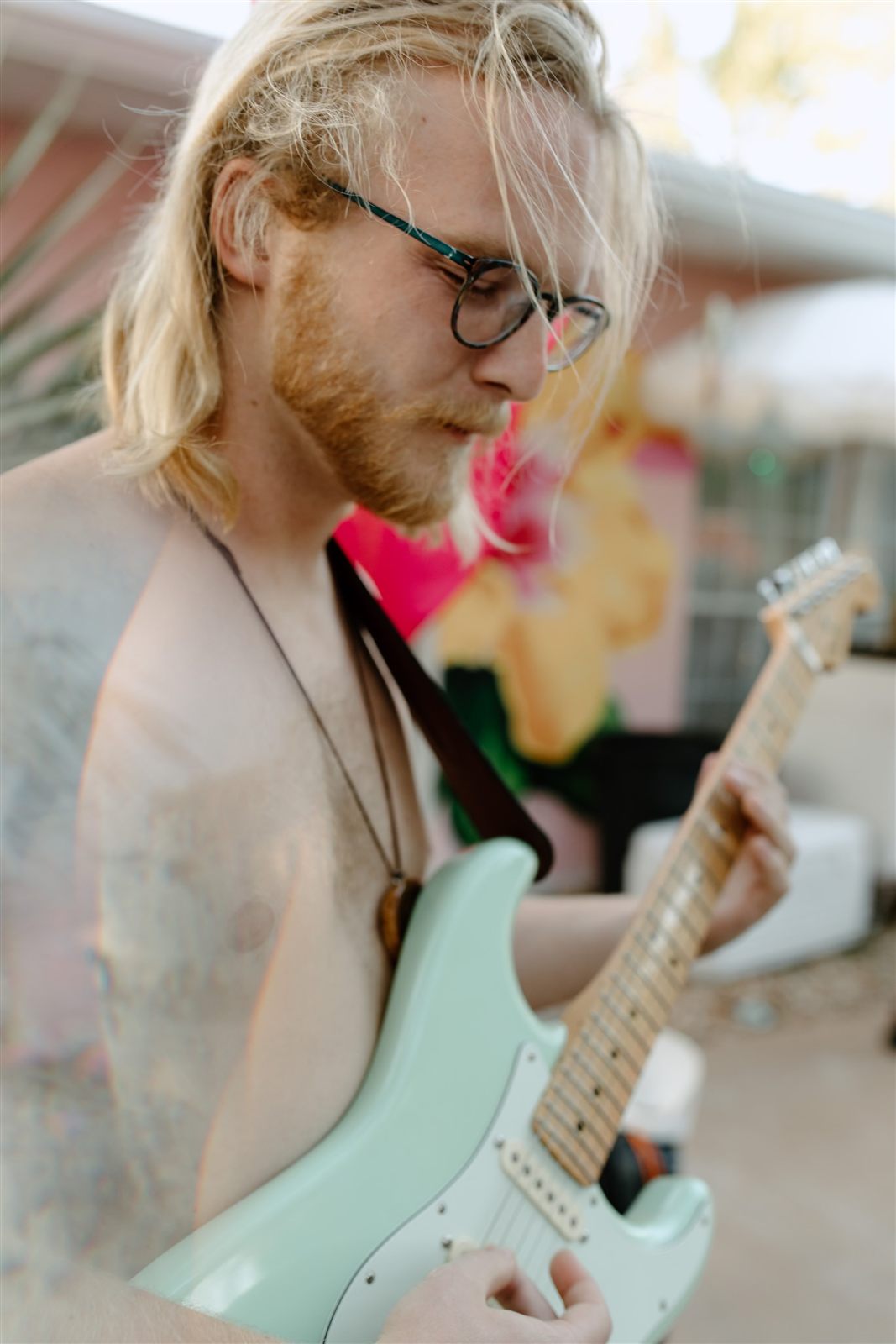 Benjamin Ballard playing guitar outdoors