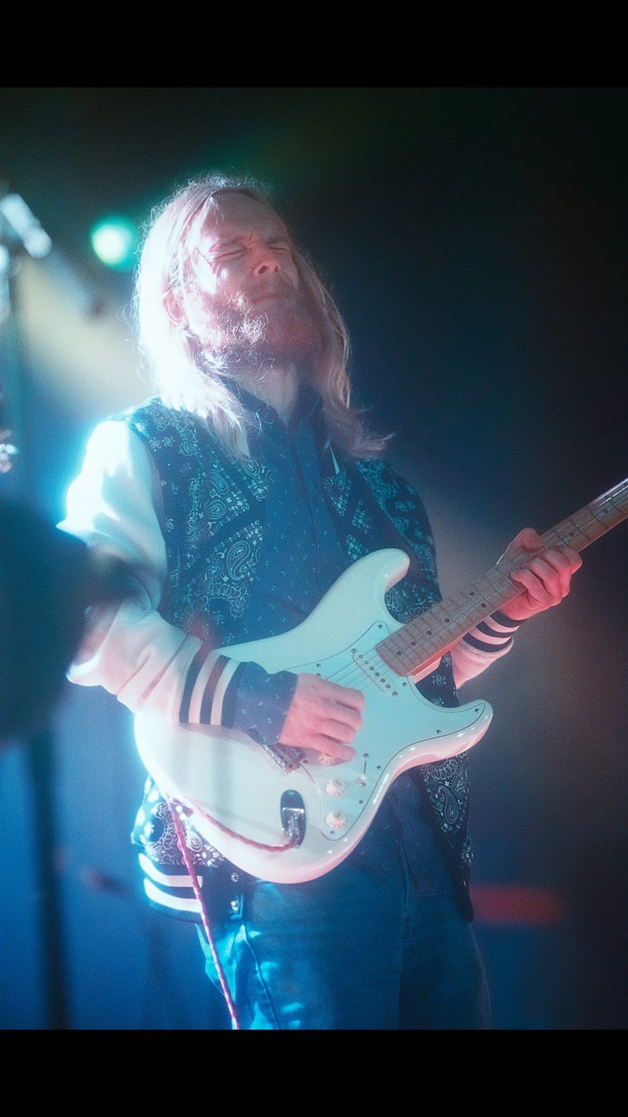 Benjamin Ballard under blue stage lighting