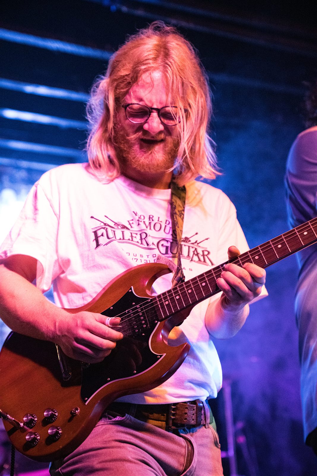 Benjamin Ballard playing guitar on stage